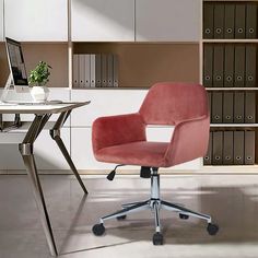 a pink office chair sitting in front of a desk with a laptop computer on it