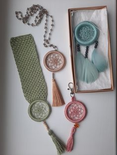 an assortment of items are displayed on a white surface, including necklaces and pendants