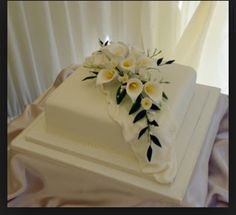 a square white cake with flowers on top