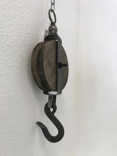 a hook is attached to the wall with a chain hanging from it's side