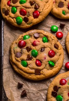 chocolate chip cookies with m & m candies and candy on parchmented baking sheet