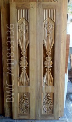 two wooden doors with decorative carvings on them