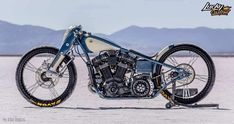 a blue and white motorcycle parked in the desert