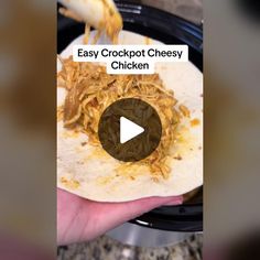 a person holding a tortilla with shredded chicken on it and the text easy crockpot cheesy chicken