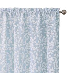 a blue and white curtain with leaves on it