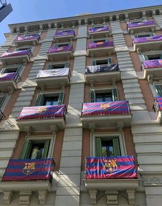 a tall building with lots of windows and balconies