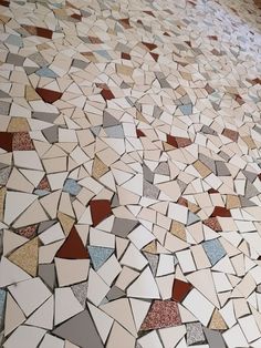 the floor is made up of many different colored tiles