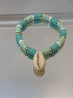 a beaded bracelet with a shell on it