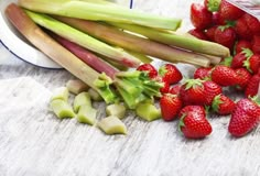 strawberries, celery, and other fruits are on the table