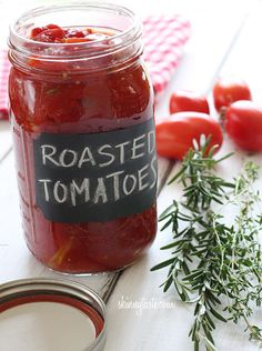 a jar filled with tomatoes sitting on top of a table