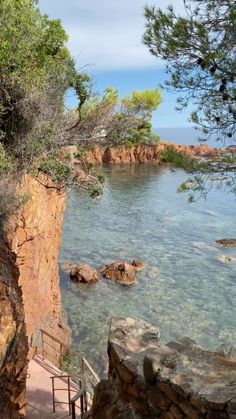 stairs lead down to the water from a cliff