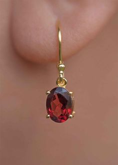 Our Garnet Dangle Earrings in gold vermeil are just the right size to be noticed and small enough to wear all day comfortably. The stone is a large 8mm natural deep red genuine Garnet popular as a January birthstone. Also available in sterling silver, see earrings section. Sold as a pair, comes with extra silicone ear backs to keep them secure. DETAILS * Dimensions: 8mm x 6mm, total length - 24mm * Material: 18k gold vermeil over 925 sterling silver base, genuine Garnet * Birthstone month - Janu Garnet Earrings Gold, Red Dangle Earrings, Gemstone Earrings Dangle, Garnet Birthstone, Drop Earrings Gold, Cut Earrings, Garnet Jewelry, January Birthstone, Garnet Earrings