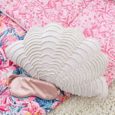 a pair of pink ballet shoes sitting on top of a pillow