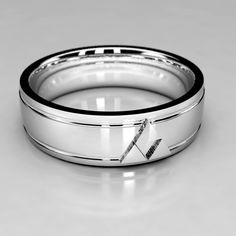 a wedding ring with an arrow in the center and two black bands around it, on a white surface