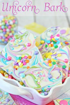 unicorn bark cookies in a white dish with sprinkles and candy on top