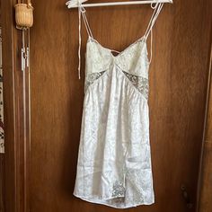 Elegant White Slip Dress With Delicate Lace Trim. Features Adjustable Straps And A Flattering Fit. Slip Dress Nightgown, For Love And Lemons Slip Dress, Slip Dress Outfit Aesthetic, White Silk Slip Dress, Lana Concert, 2025 Wishlist, Kitten Dress, Slip Dress Outfit, Slip Dress With Lace