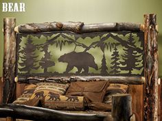 a bed made out of logs with an image of a bear on the headboard