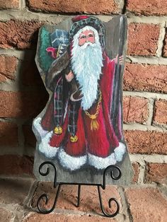 a wooden sign with a santa clause on it