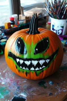 a painted pumpkin sitting on top of a table