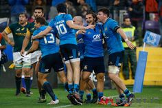 rugby players are congratulating each other on the field