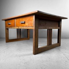 a wooden table with two drawers on each side