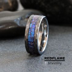 a ring with blue and purple opal inlays on the inside of it