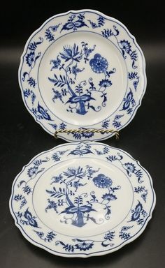 two blue and white plates with flowers on them