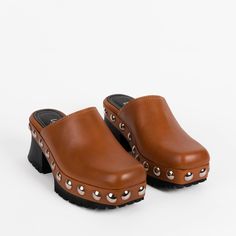 Classic closed-toe clog with wraparound chrome studs. The rubber-bottomed ayous-wood outsole is grippy, lightweight, and flared at the heel. Bryr Clogs, High Heel Sandals Platform, Brown Clogs, Mule Heels, Clogs And Mules, Wooden Clogs, Womens Mules, Only Shoes, Doll Shoes