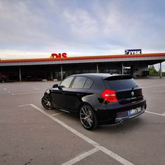 a black car parked in a parking lot