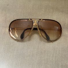 Vintage Cazal Gold Metal Aviator Sunglasses. Made In West Germany, These Currently Have Tinted Prescription Lenses But Those Could Easily Be Changed Out By A Professional. These Are Sturdy, And Although They’re Worn, They’re In Great Condition Considering Their Age- One Small Spot Of Wear On Interior Left Frame. Please See Photos, And Let Me Know If You Need Additional Pictures. Accessories Vintage, West Germany, Aviator Sunglasses, Prescription Lenses, See Photo, Sunglasses Accessories, Gold Metal, Lenses, Hollywood