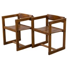 two wooden chairs sitting next to each other