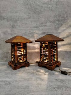 two wooden lamps sitting next to each other