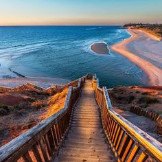 stairs lead down to the beach at sunset