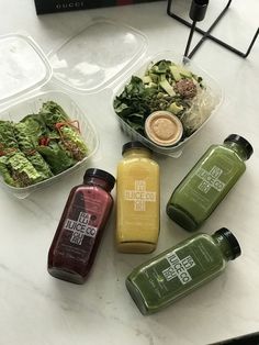 there are many different types of juices on the counter top, including salad and smoothie