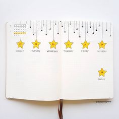 an open notebook with yellow stars hanging from it