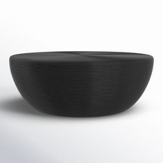 a black bowl sitting on top of a white table