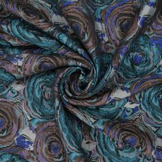 a blue and brown fabric with swirls on it's side, in the middle