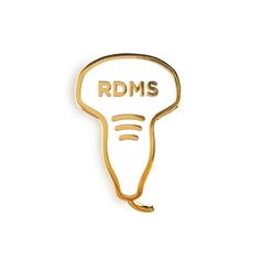 a gold brooch with the words rdms on it