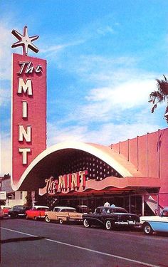 cars are parked in front of the mintt theater