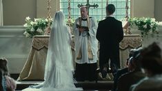 a bride and groom standing at the alter in front of an altar during a wedding ceremony