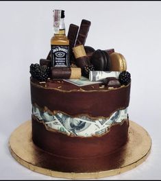 a chocolate cake with liquor and cigars on top