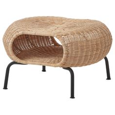 a wicker lounge chair with black metal legs and an oval shaped cushion on top