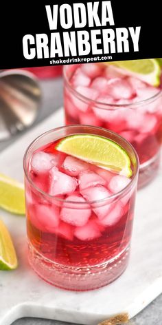 two glasses filled with vodka cranberry punch and lime wedges on the side