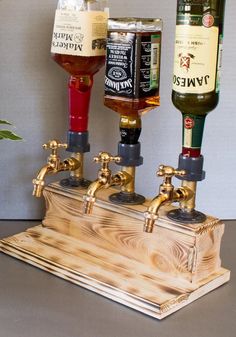 three beer taps sitting on top of a wooden box