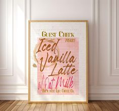 a framed poster with the words guest check and feed vanilla latte next to it