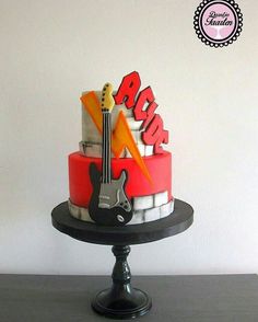 a birthday cake with an electric guitar on top