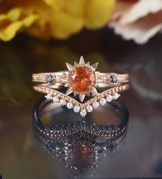 a close up of a ring on a table with flowers in the background