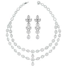 The Tara Necklace & Earrings Suite features a elegant timeless design that highlights each diamond and impresses with its simple yet stated style. Its bold earrings bring attention Diamonds Shapes: Pear Shape, Oval, Marquise & Round Total Diamonds Weight: 24.74 ct (Necklace) & 6.59 ct (Earrings) Diamonds Color: F - H Diamonds Clarity: SI (Slightly Included) Metal: 18K White Gold Metal Wt: 53 gms (Necklace) & 20.55 gms (Earrings) Setting: Prong Set Length: 15.5 Inches & 2.6 Inches Price Quoted ma Diamonds Shapes, Dna Earrings, Earrings Diamonds, Pearl Chandelier Earrings, Diamond Chandelier Earrings, Noble Lady, Stones Necklace, Earrings Chandelier, Aesthetic Edits