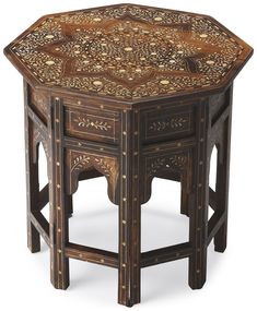 an octagonal table with carved wood inlays