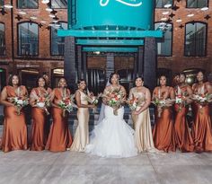 a group of women standing next to each other in front of a building